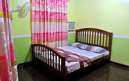 Queen-size Bed with Aircon & Electric Fan inside the Room (1st Floor)